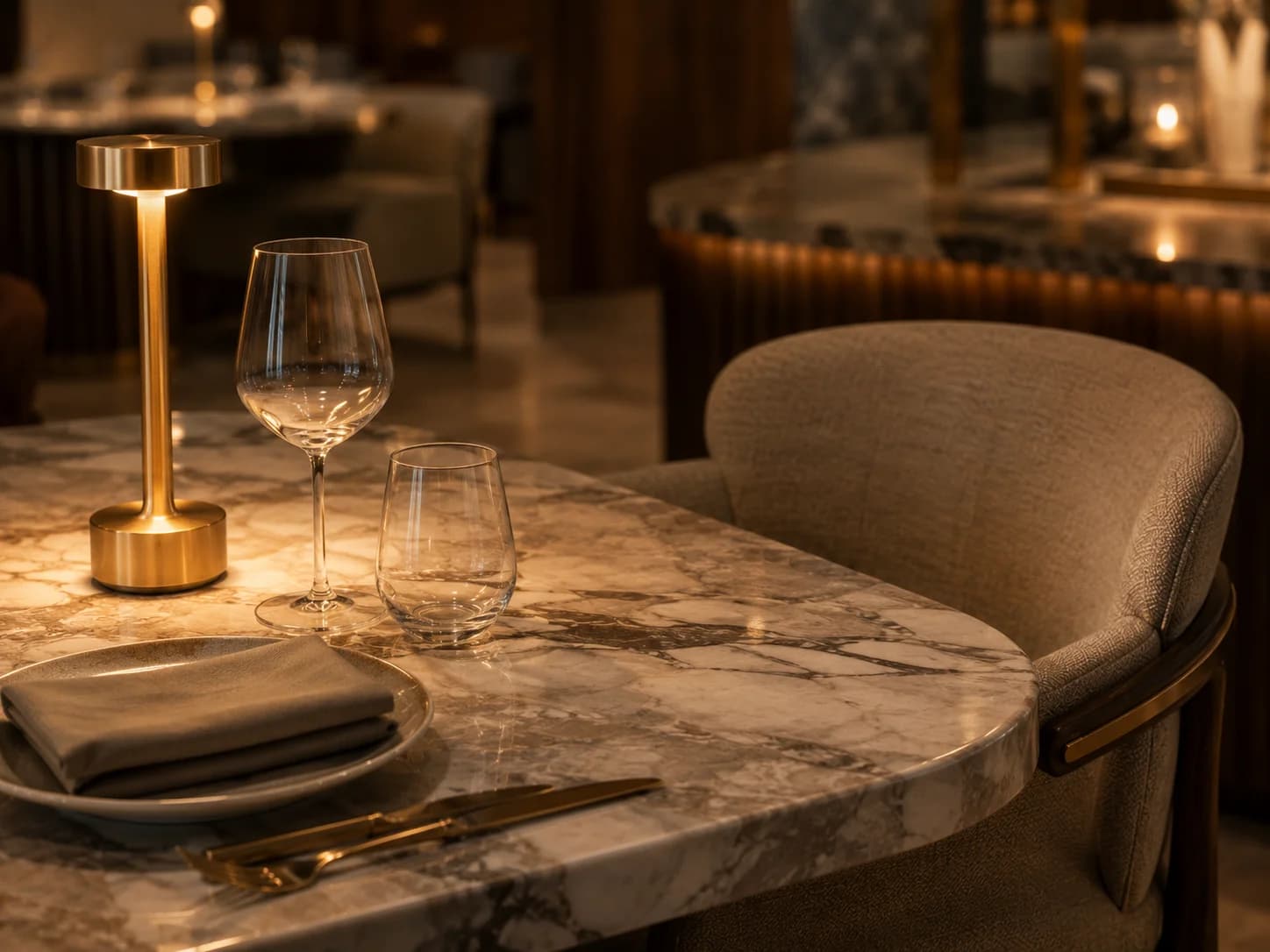 Luxury Restaurant Dining Table Detail Dubai Close-up of marble dining table with sculptural brass lighting in a luxury restaurant