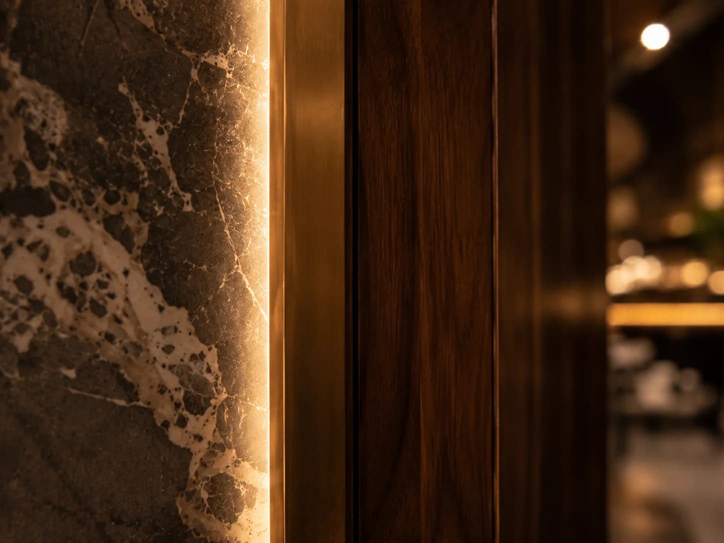 Luxury Restaurant Stone and Brass Detailing Dubai Close-up of natural stone, brass and walnut detailing in a luxury restaurant interior
