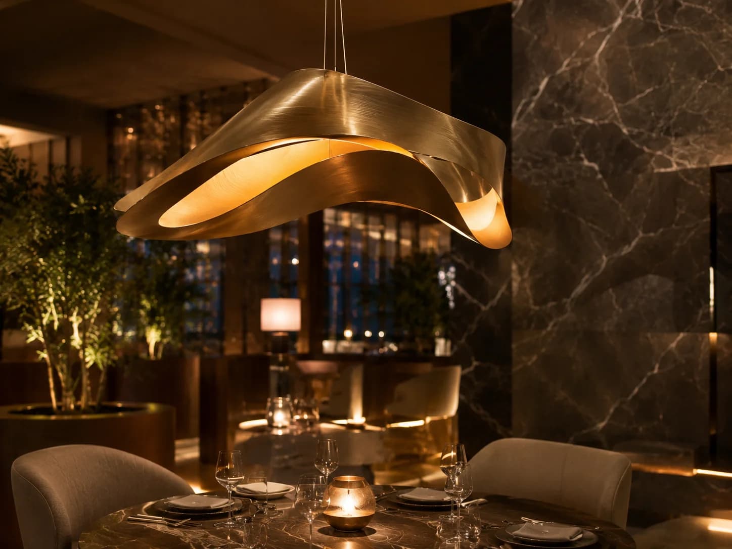 Sculptural Restaurant Pendant Lighting Dubai Close-up of a sculptural brass pendant light in a luxury restaurant interior